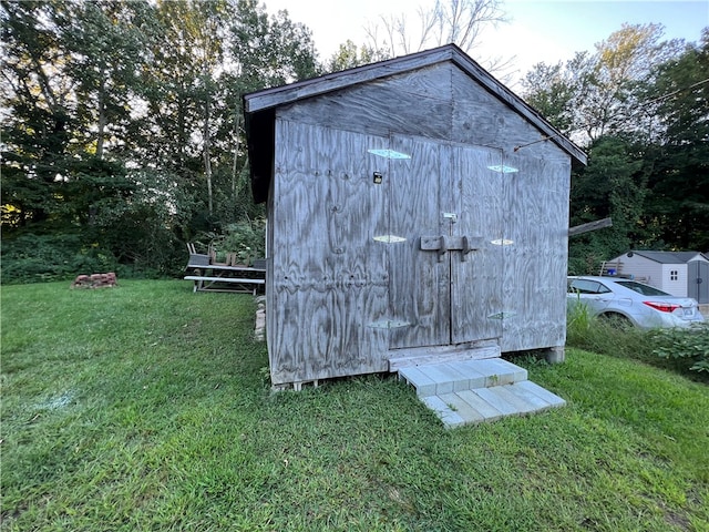 view of outbuilding with a yard