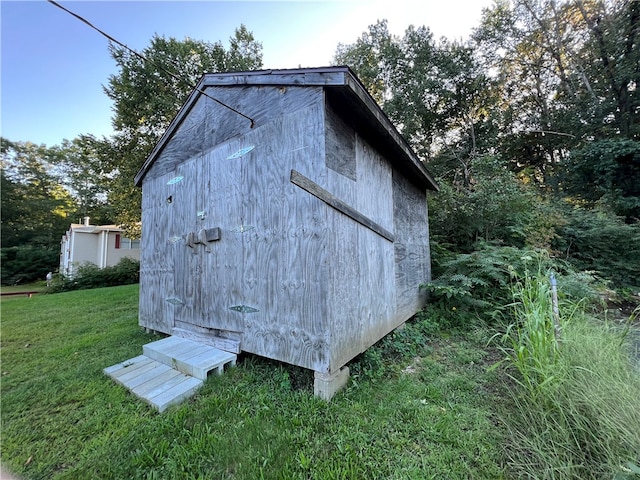 view of outbuilding featuring a yard