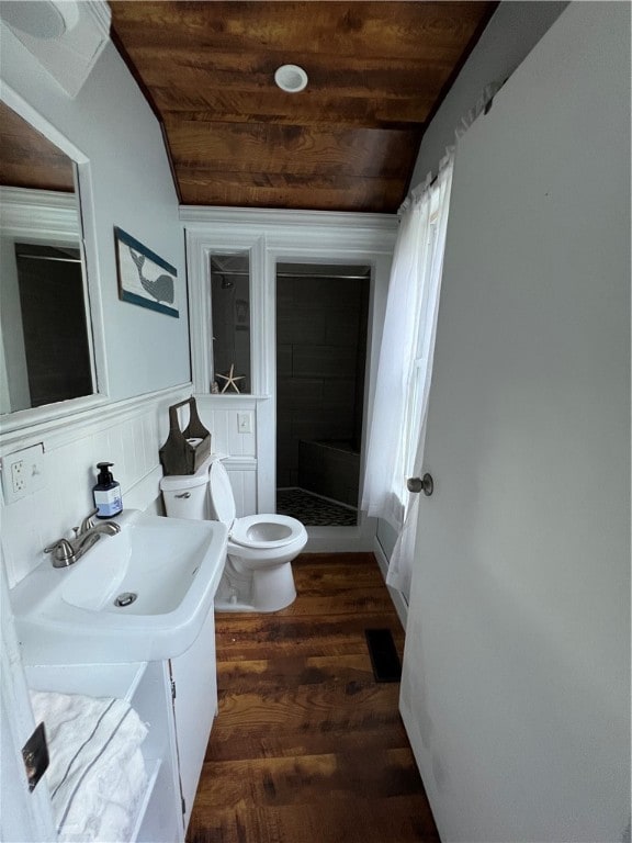 bathroom with toilet, wood ceiling, vanity, and a shower