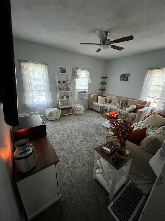 living room featuring ceiling fan, carpet flooring, and a wealth of natural light