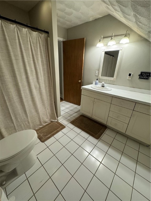 bathroom featuring curtained shower, a textured ceiling, toilet, vanity, and tile patterned flooring