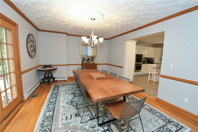 dining area with an inviting chandelier, ornamental molding, a baseboard heating unit, and light wood-type flooring