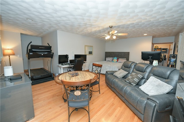 living room featuring light hardwood / wood-style floors and ceiling fan