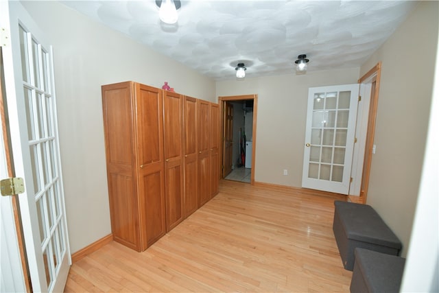 corridor with light hardwood / wood-style floors