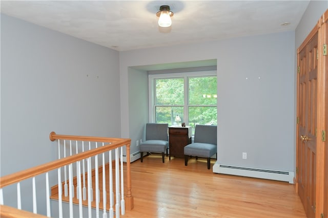 living area featuring light hardwood / wood-style floors and a baseboard radiator