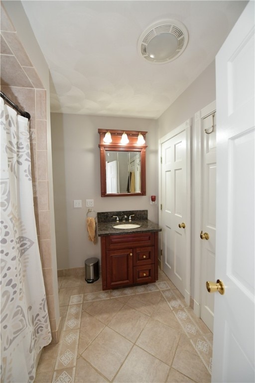 bathroom featuring vanity, tile patterned floors, and a shower with shower curtain