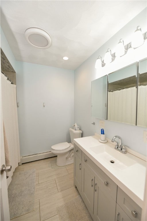 bathroom featuring baseboard heating, vanity, hardwood / wood-style flooring, and toilet