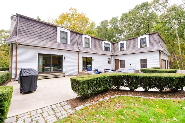 back of house with an outdoor hangout area and a patio area