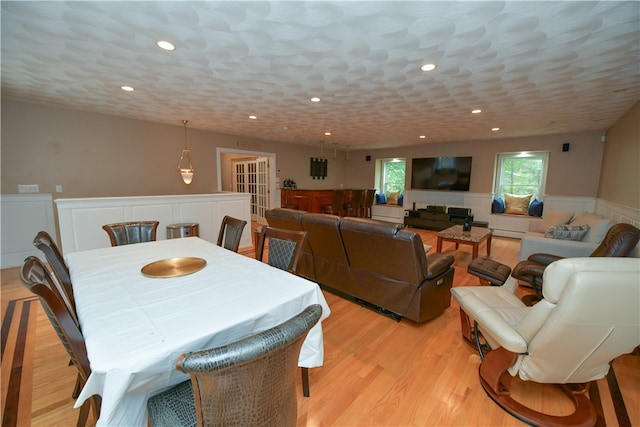 dining space featuring baseboard heating and light wood-type flooring