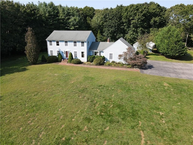 colonial home with a front lawn