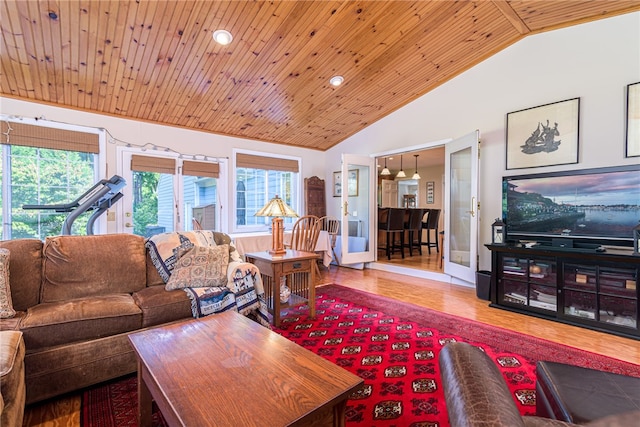 living room featuring vaulted ceiling, wood ceiling, plenty of natural light, and french doors