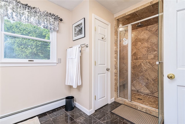 bathroom with a shower with shower door and baseboard heating