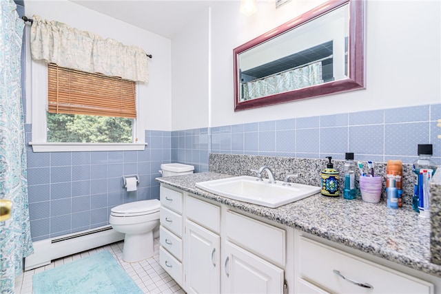 bathroom featuring toilet, vanity, tile patterned flooring, tile walls, and a baseboard radiator