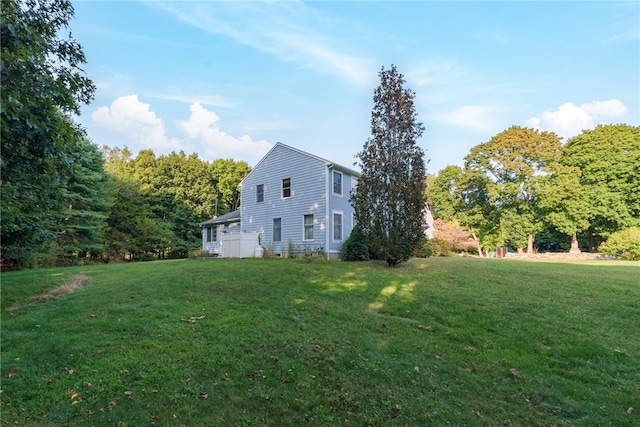 view of side of home featuring a yard