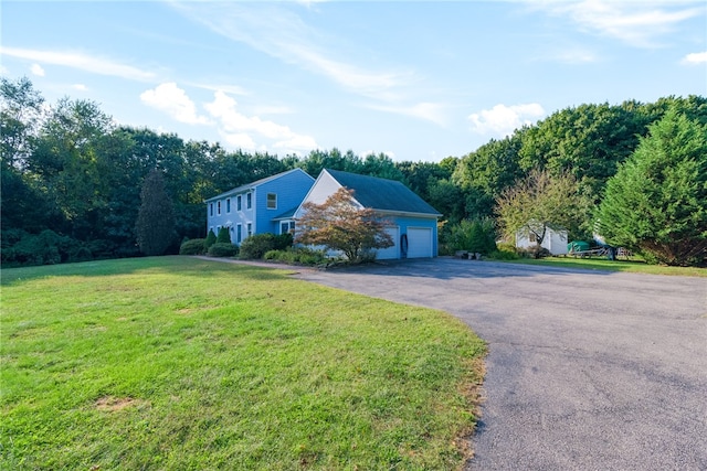 view of front of home with a garage and a front yard