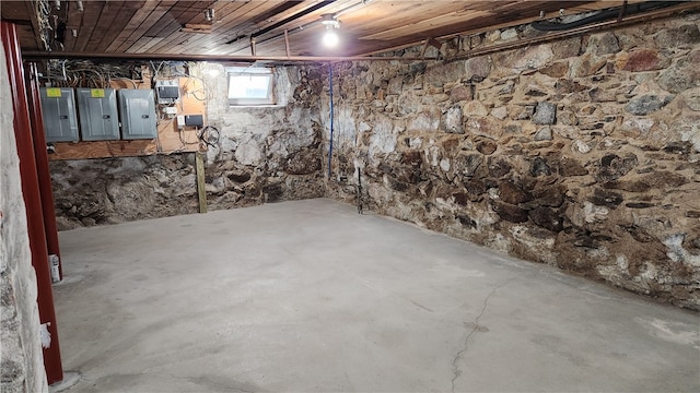 basement featuring wood ceiling and electric panel