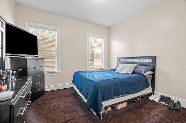 bedroom with a baseboard radiator and dark colored carpet