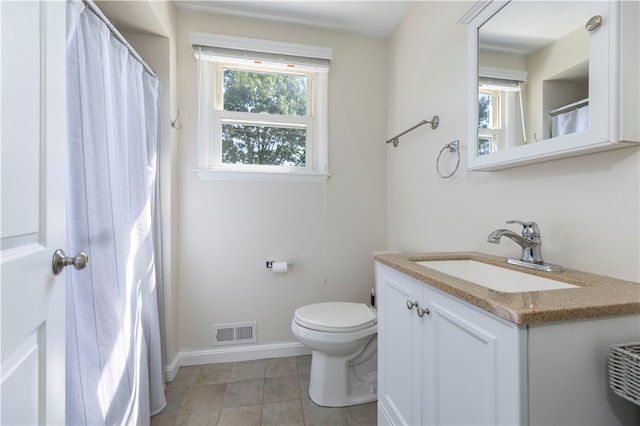 bathroom featuring vanity, toilet, and tile patterned floors