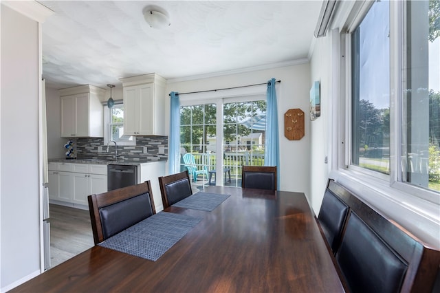 dining room featuring ornamental molding, dark wood-type flooring, and sink