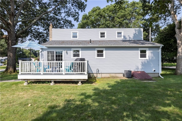 back of house with a wooden deck, a lawn, and central AC unit