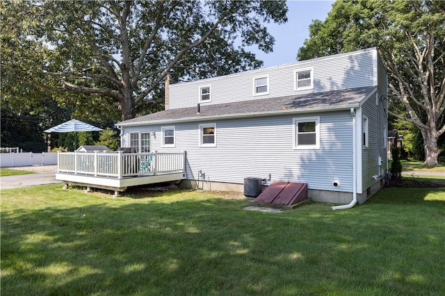 back of property featuring a yard, a deck, and central air condition unit