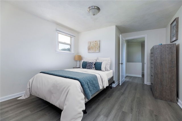 bedroom with dark hardwood / wood-style flooring