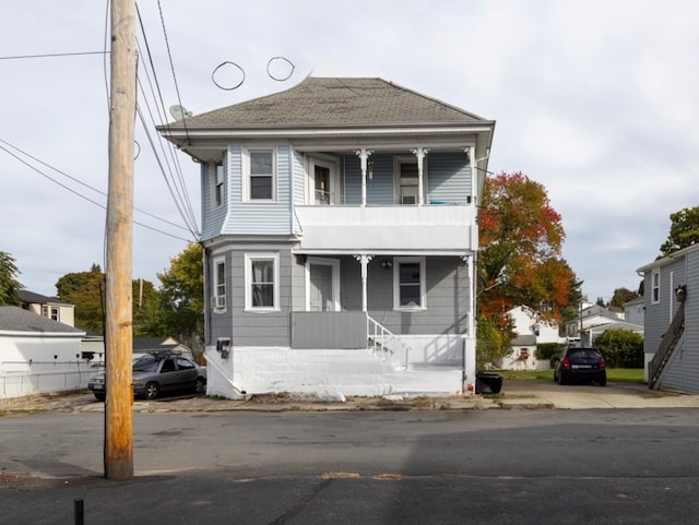 view of front property with covered porch and a balcony