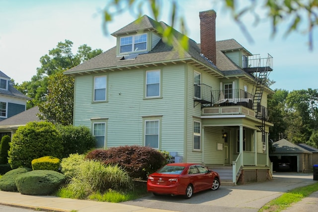 view of front of property with a balcony and a garage