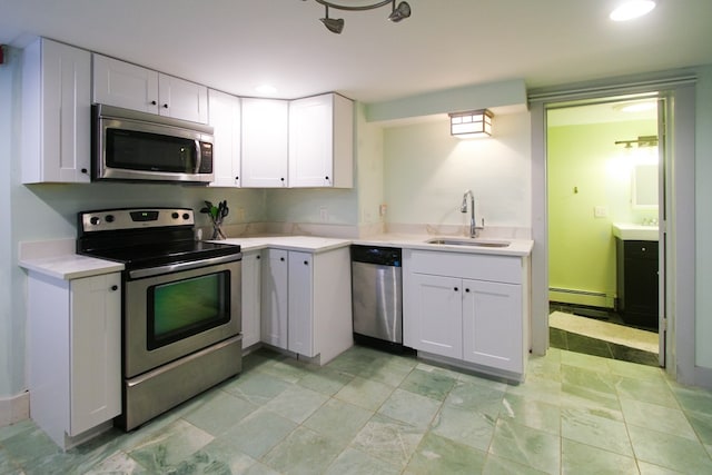 kitchen with white cabinetry, stainless steel appliances, sink, and a baseboard radiator