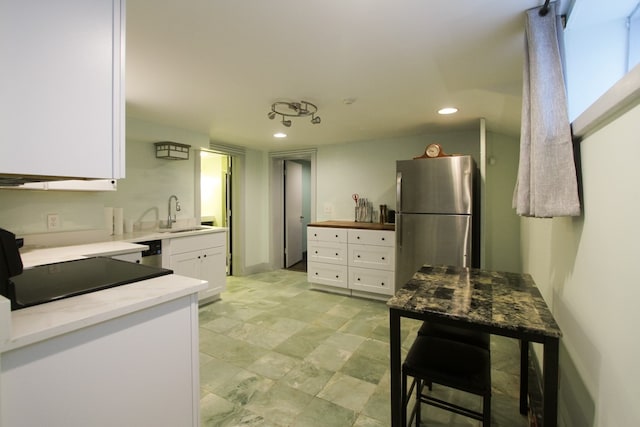 kitchen featuring sink, white cabinets, and stainless steel appliances