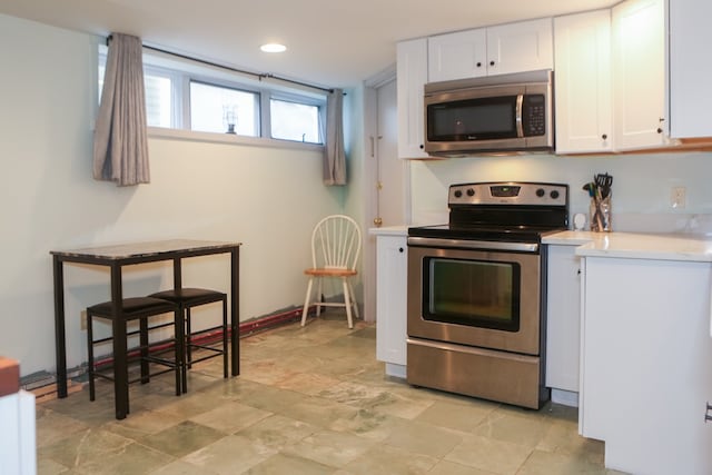 kitchen featuring appliances with stainless steel finishes and white cabinets