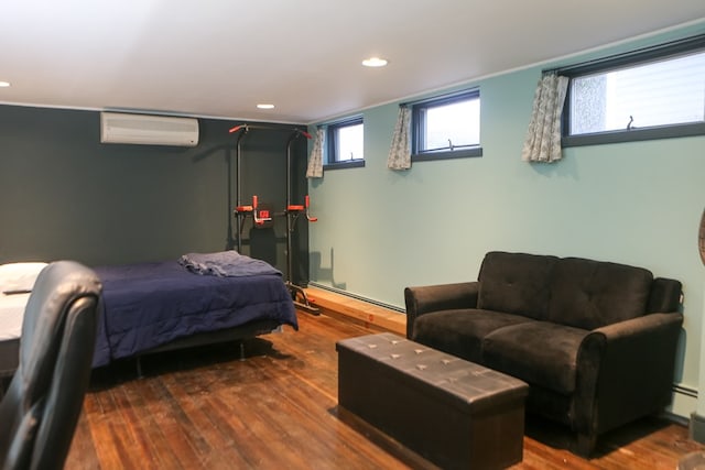 bedroom featuring an AC wall unit and dark hardwood / wood-style floors