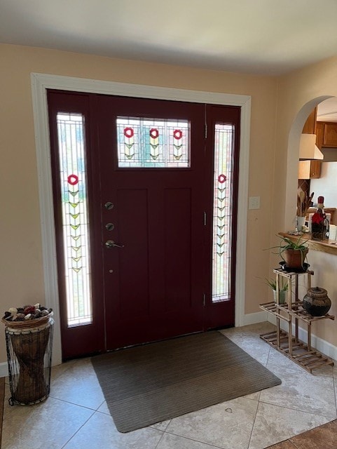 foyer entrance with light tile patterned flooring