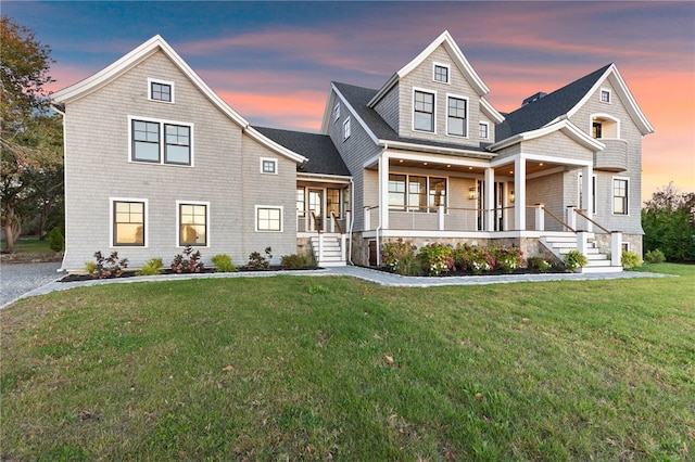 view of front of house with a yard and a porch