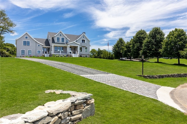 craftsman-style home featuring a front yard and covered porch