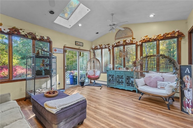 interior space with ceiling fan and vaulted ceiling with skylight