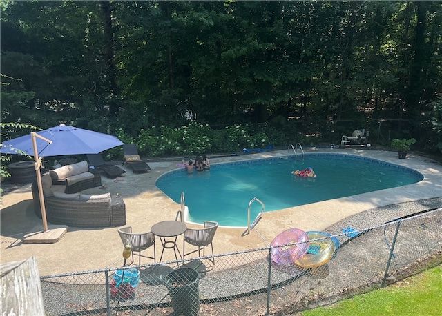 view of swimming pool with a patio