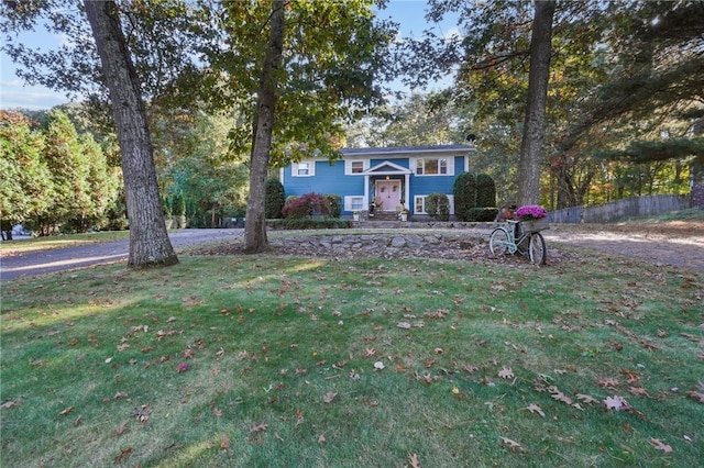 bi-level home with a front lawn