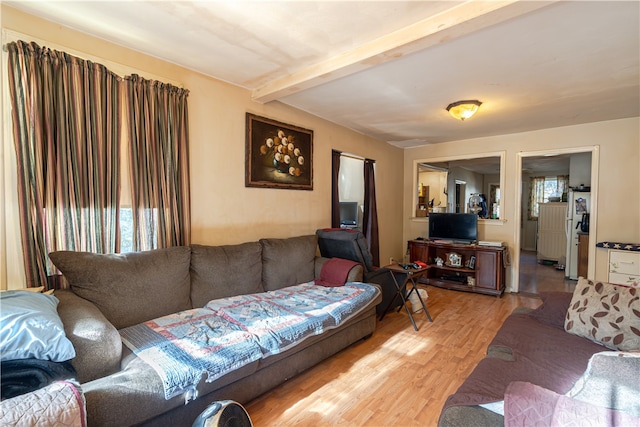 living room with hardwood / wood-style flooring and beamed ceiling