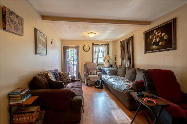 living room with beam ceiling and light hardwood / wood-style flooring