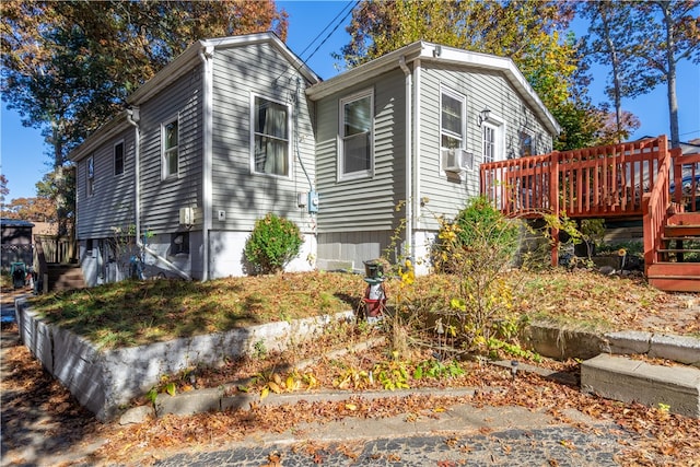 view of side of home featuring a wooden deck and cooling unit