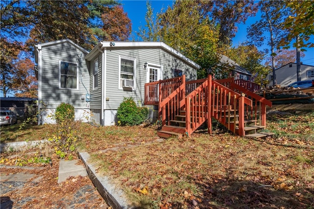 rear view of house featuring a deck