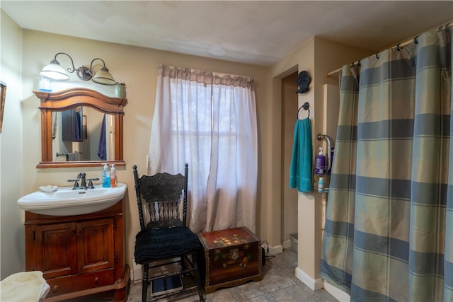 bathroom with vanity, walk in shower, and tile patterned flooring