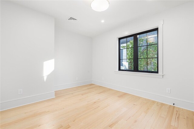 spare room featuring light hardwood / wood-style flooring