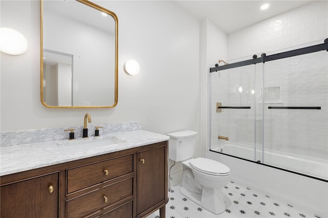 full bathroom featuring toilet, enclosed tub / shower combo, and vanity