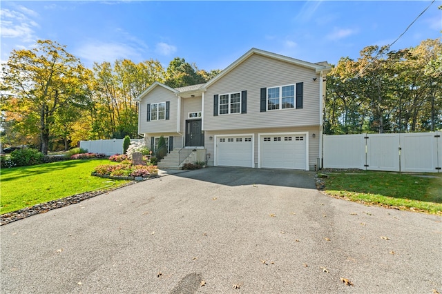 bi-level home featuring a front yard and a garage