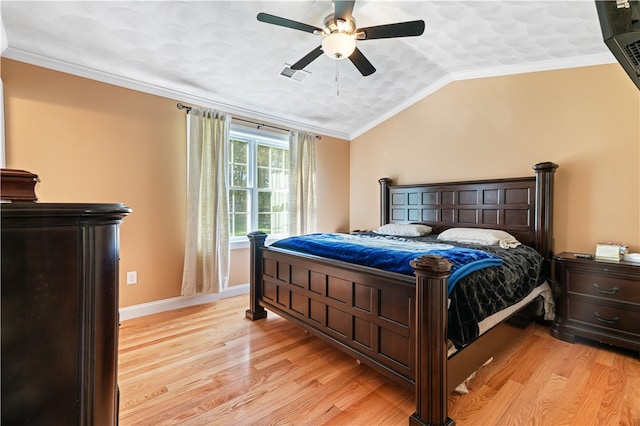 bedroom with crown molding, lofted ceiling, light wood-type flooring, and ceiling fan