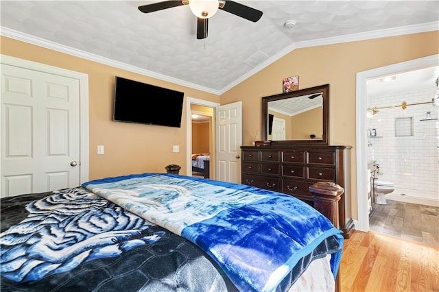 bedroom with ceiling fan, vaulted ceiling, ornamental molding, ensuite bathroom, and light hardwood / wood-style floors