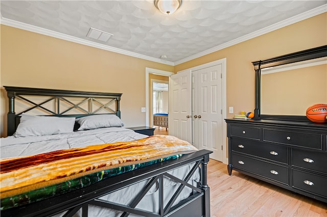 bedroom with crown molding and light wood-type flooring