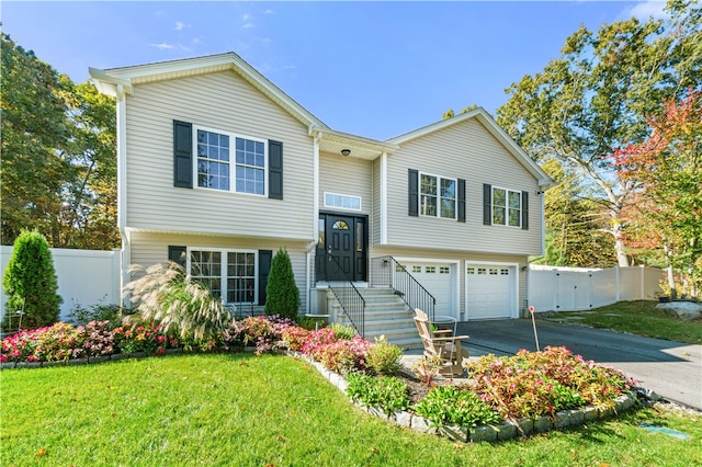 split foyer home featuring a front yard and a garage